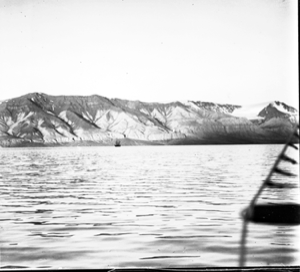 Image of Nearby hills along coast. Three-masted vessel beyond